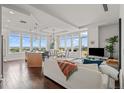 Open living space with hardwood floors, city views, and kitchen island at 5455 Landmark Pl # 604, Greenwood Village, CO 80111
