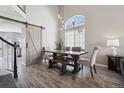 Dining area features a modern table with a wooden bench, large windows, and stylish decor at 1461 Hickory Ct, Erie, CO 80516