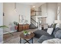 Spacious living room with staircase, hardwood floors, neutral tones and modern furnishings at 1461 Hickory Ct, Erie, CO 80516