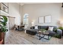 Bright open-concept living room featuring high ceilings, a barn door, and modern furniture at 1461 Hickory Ct, Erie, CO 80516