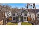 Charming two-story duplex with well-maintained lawn and mature trees providing shade and curb appeal at 2430 Ames St, Edgewater, CO 80214