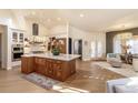 Spacious open kitchen with a wooden island and chandeliers at 93 Glenmoor Dr, Englewood, CO 80113