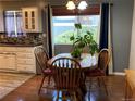 Bright dining area with a wooden table, chairs, and a view of the outdoors at 6585 W 84Th Way # 109, Arvada, CO 80003