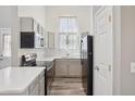 Modern kitchen with stainless steel appliances, sleek countertops, and stylish gray cabinetry at 10711 Longs Way, Parker, CO 80138