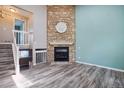 Spacious living room featuring a stone fireplace, hardwood floors, and plenty of natural light at 10711 Longs Way, Parker, CO 80138