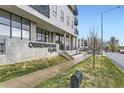 Beautiful condo building featuring modern architectural design, signage and manicured lawn at 2374 S University Blvd # 402, Denver, CO 80210