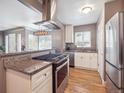 Open kitchen featuring stainless appliances, granite countertops and eat in kitchen at 20 S Harrison St, Denver, CO 80209