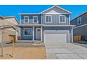 Charming two-story home with a two-car garage and blue siding at 4201 Sandstone Dr, Mead, CO 80504