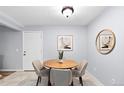 A dining area showcasing a round wooden table with modern chairs, with contemporary artwork enhancing the wall decor at 16259 W 10Th Ave # I2, Golden, CO 80401