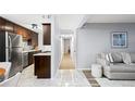 An open-concept floor plan with a modern kitchen and living area, featuring stainless steel appliances and a cozy sofa at 16259 W 10Th Ave # I2, Golden, CO 80401