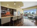 Modern kitchen with breakfast bar, stainless steel appliances, tile backsplash, and open layout to the living area at 2001 Lincoln St # 2420, Denver, CO 80202