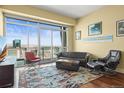 Bright living room featuring floor-to-ceiling windows with city views, modern furniture, and elegant hardwood floors at 2001 Lincoln St # 2420, Denver, CO 80202