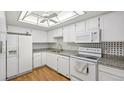 Well-maintained kitchen featuring white cabinetry, granite countertops, and modern appliances at 13601 E Marina Dr # 604, Aurora, CO 80014