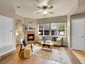 Bright living room with a fireplace, large windows, and hardwood flooring at 16366 E Fremont Ave # 3, Aurora, CO 80016