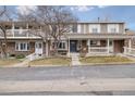 Charming townhouse showcasing a well-maintained exterior with brick and covered porches at 7272 E Appleton Cir, Centennial, CO 80112