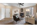 Inviting living room featuring a cozy fireplace, stylish decor, and a view of the front door at 7440 S Blackhawk St # 205, Englewood, CO 80112