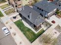 Aerial view of a gray two-story home, fenced yard, patio area, and landscaping at 2135 W 40Th Ave, Denver, CO 80211