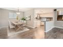 Dining area with a light wood table and seating for four, plus modern decor at 9014 W Harvard Dr, Lakewood, CO 80227