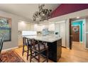 Spacious kitchen with an island, white cabinets, and hardwood floors, perfect for cooking and entertaining at 474 Silbrico Way, Castle Rock, CO 80108