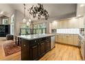 Large kitchen island with stone countertops, designer lighting, and stainless steel appliances, creating a modern space at 474 Silbrico Way, Castle Rock, CO 80108