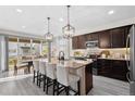 A modern kitchen featuring an island with bar seating, stainless steel appliances, and ample counter space at 2637 Gray Wolf Pl, Castle Rock, CO 80104