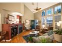 Bright living room featuring hardwood floors, a fireplace, and ample natural light from large windows at 8300 Fairmount Dr # Qq102, Denver, CO 80247