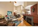 Inviting living room with hardwood floors, a cozy fireplace, and soaring ceilings, creating an open and airy atmosphere at 8300 Fairmount Dr # Qq102, Denver, CO 80247