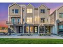 Townhome exterior showcasing brick accents, covered entryways, and modern design; a cozy and inviting facade at 888 S Valentia St # 103, Denver, CO 80247