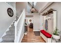 Inviting entryway with hardwood floors, coat rack, and stairway leading to the upper level at 4416 Brentwood St, Wheat Ridge, CO 80033