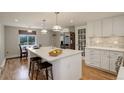 Bright kitchen with white cabinets, a spacious island, and stainless steel appliances at 4416 Brentwood St, Wheat Ridge, CO 80033