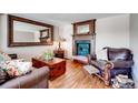 Cozy living room featuring a fireplace, hardwood floors, and comfortable seating at 4416 Brentwood St, Wheat Ridge, CO 80033