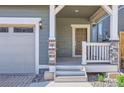 Inviting front porch with stone accents and a stylish entrance to this well-maintained home at 645 Flintwood Pl, Lafayette, CO 80026