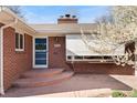 Close up of the front entrance with a brick facade and a wreath on the door at 5285 E Iliff Ave, Denver, CO 80222