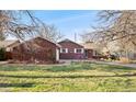 Charming brick home with a well-manicured front yard and mature trees at 5285 E Iliff Ave, Denver, CO 80222