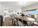 Open concept design with modern kitchen featuring an island, dining area, and outdoor access at 17125 W 92Nd Loop, Arvada, CO 80007