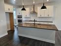Bright, open kitchen with an island, pendant lights, white cabinets, and stainless steel appliances at 17125 W 92Nd Loop, Arvada, CO 80007