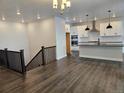 Open-concept living space that flows from the kitchen to the living room, with hardwood floors at 17125 W 92Nd Loop, Arvada, CO 80007