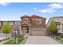 Beautiful two-story home with a stone facade, a two-car garage, and a well-maintained lawn at 5311 Blue Lunar Ln, Castle Rock, CO 80104