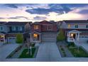 Beautiful two-story home with stone accents, a two-car garage, and a landscaped front yard at twilight at 5311 Blue Lunar Ln, Castle Rock, CO 80104