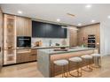 Gourmet kitchen featuring a large island, modern cabinetry, and stainless steel appliances for modern cooking at 1518 S Columbine St, Denver, CO 80210