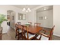 A spacious dining room with wooden table and chairs, bathed in natural light at 6739 Blue Spruce St, Frederick, CO 80530