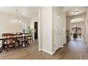 Elegant hallway with hardwood floors and access to a dining room and office space at 6739 Blue Spruce St, Frederick, CO 80530