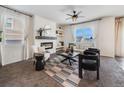 Living room with a fireplace, comfy seating, and a large window at 6044 Point Rider Cir, Castle Rock, CO 80104
