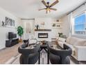 Living room with a fireplace, seating area, and large windows at 6044 Point Rider Cir, Castle Rock, CO 80104