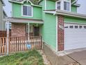 Charming front porch with wood railing and brick accents at 12025 Monaco Dr, Brighton, CO 80602