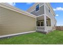 The side and back of a two-story home that has a porch and a grassy yard at 203 Washington St, Erie, CO 80516