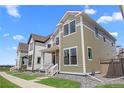 A lovely two-story home boasting a cozy front porch and a well-kept lawn in a peaceful neighborhood setting at 203 Washington St, Erie, CO 80516