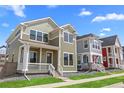A quaint two-story home featuring a welcoming front porch and well-manicured lawn in a vibrant neighborhood at 203 Washington St, Erie, CO 80516