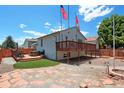 Backyard featuring a spacious deck, hot tub, artificial turf and a partially bricked ground at 2800 Troxell Ave, Longmont, CO 80503