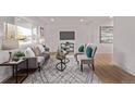 Bright living room with a large window, comfortable seating, and stylish decor, perfect for relaxation at 9120 Judson St, Westminster, CO 80031
